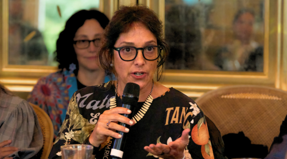 Nia Tero staff attend Climate Week NYC event, with Daniela Lerda in the foreground holding a microphone