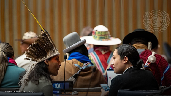During the conference forum event, two Indigenous men engaged in discussion.