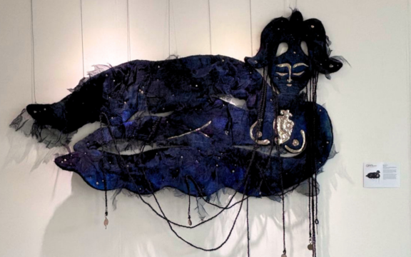 A large blue and black felt representation of the goddess of fertility in Tengrism