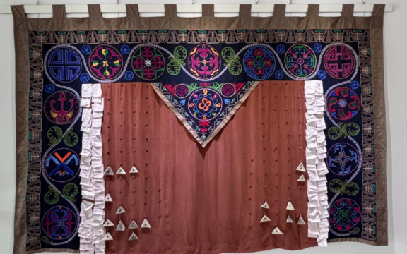 Photo of multicolored tapestry titled 'Infinity'