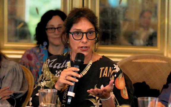 Nia Tero staff attend Climate Week NYC event, with Daniela Lerda in the foreground holding a microphone