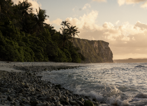 Rocky coastal shoreline at sunset.