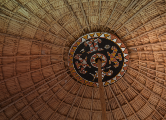 Interior featuring a circular wooden roof pattern design.